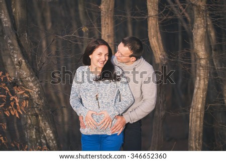 Pregnancy, maternity and family picture in outdoors, late November