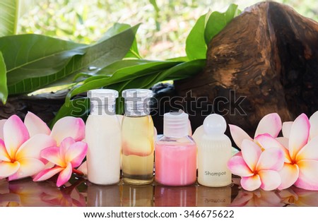 mini set of bubble bath shower and natural treatment shampoo conditioner with flowers plumeria or frangipani in outdoor bathroom, aroma spa mini set of bubble bath and shower gel set for body and hair