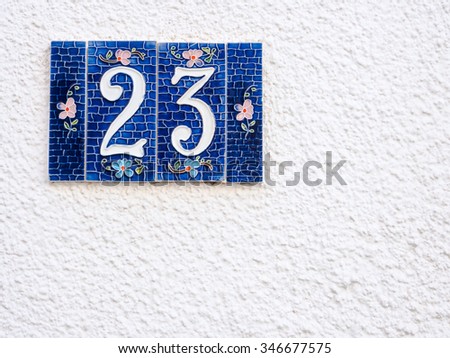 Street number 23. Particular of artistic street number