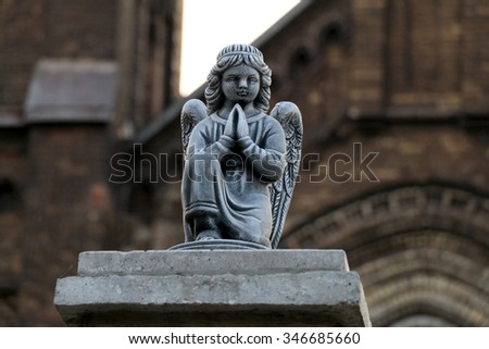 figurine of an angel at the entrance to the catholic cathedral