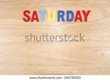 Saturday word by wooden letters on wood background (Weekdays word series)