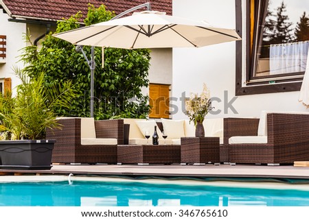 a luxurious lounge on the poolside of a beautiful big pool