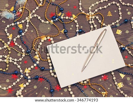 New year. Letter to Father Frost, Letter to Santa Claus. A New Year's background with a beads and confetti on a table, the top view. Congratulation, card, invitation.