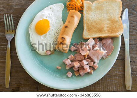 Breakfast food  sunny egg , sausage , toast , bacon in dish . vintage picture style
