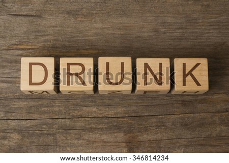text of DRUNK on wooden cubes