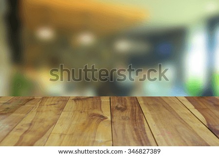 Wooden table and  blurred photo coffee shop background
