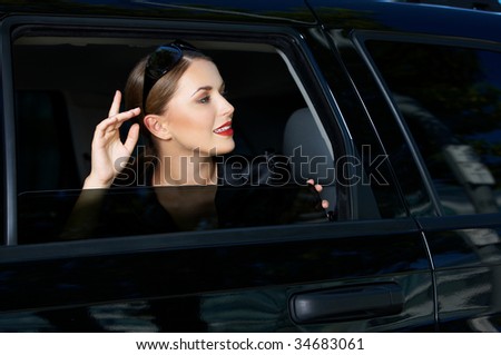 Portrait of beautiful business woman inside the limo car