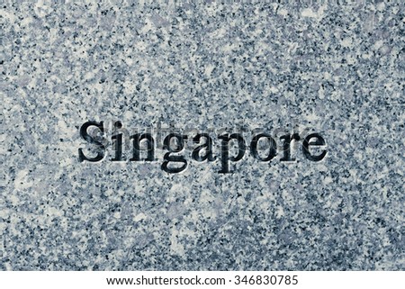 Engraving spelling the city Singapore on textured old surface