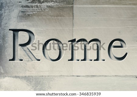 Engraving spelling the city Rome on textured old surface