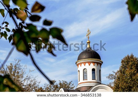 Background with bell tower of an Orthodox church of Tikhvin mother of God in Russia. Image with selective focus