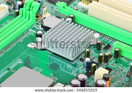 Green printed computer motherboard with microcircuit, close-up