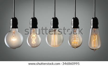 Vintage hanging light bulbs over gray background  Royalty-Free Stock Photo #346860995