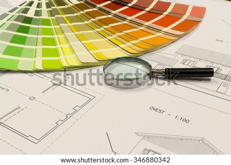An office desk with the project papers and color chart