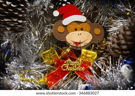 Monkey in a Christmas hat on Christmas wreaths