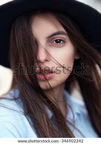 Beautiful fashionable woman in a hat
