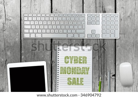 Cyber Monday message with workstation on wooden desk