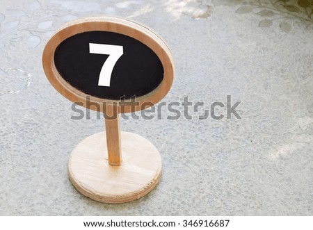 closeup number 7 on wooden sign board
