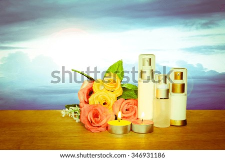 cosmetic container and candle with blur dark clouds on blue sky
