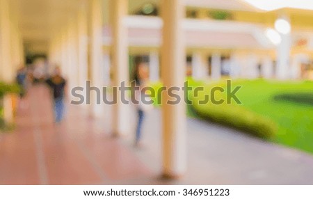 blur image of modern corridor on day time for background usage.