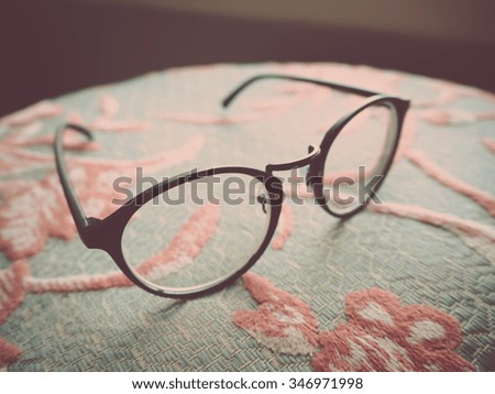 Vintage eyeglasses in window light.