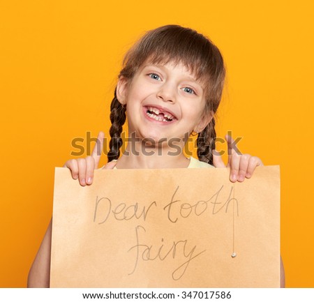 lost tooth girl portrait, studio shoot on yellow background