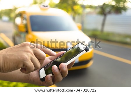 Man orders a taxi from his cell phone Royalty-Free Stock Photo #347020922