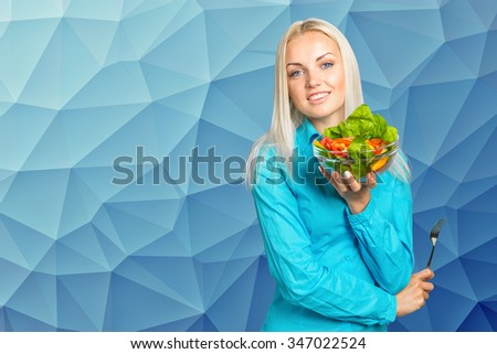 Beautiful girl eating fresh vegetable salad