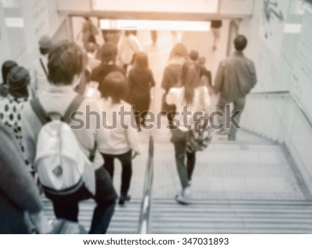 Blurred motion people in rush hour at Osaka railway Station, Japan. Vintage tone.