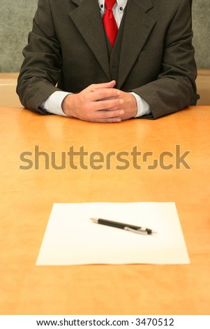 Business-man waiting at the desk for you to sign the document.