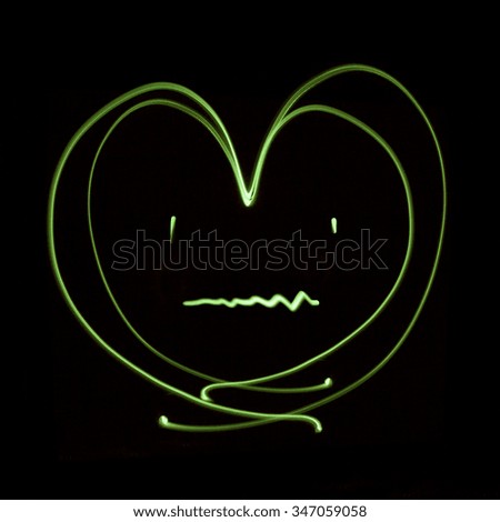 Heart patient generated by a beam of green light, with long exposure.