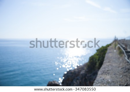 Background with bokeh, sunshine and ripple on the sea water and blue sky