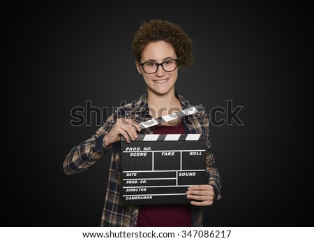 Young woman holding count on black background