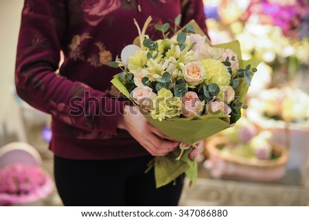pink and green bouquet  with rose and other flowers in hands 