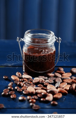 Chocolate dessert in glass on color wooden background