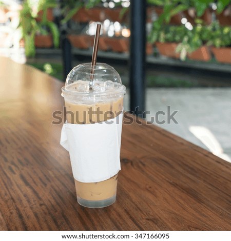 iced coffee in Coffee shop ,Iced coffee with straw in plastic cup.