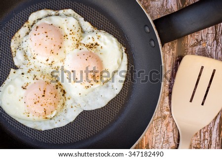 Over-easy eggs with fresh salsa and coffee  Royalty-Free Stock Photo #347182490