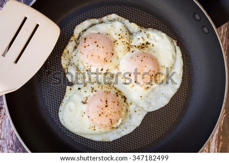 Over-easy eggs with fresh salsa and coffee  Royalty-Free Stock Photo #347182499