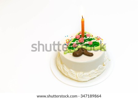 Christmas cake with Christmas tree as festive decoration on top over white background