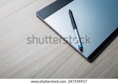 Graphic tablet with Pen. Big picture of digitizer device with digital pen on the table. Creative draw tool for designers. Icon of tablet display near multimedia pencil sketching.