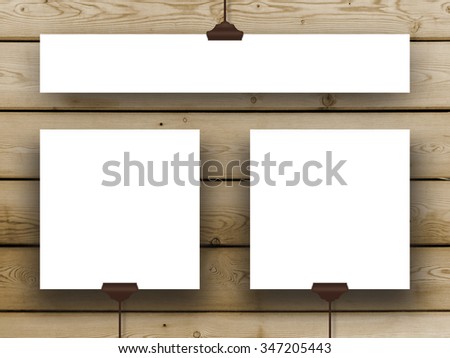 Three hanged square and rectangular frames on brown wooden boards background