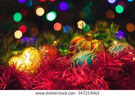 Christmas New Year's toys on a blurred background of Christmas trees and garlands.