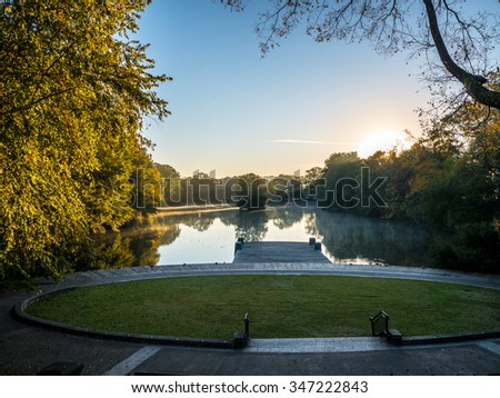 Sun through tress with reflections in lake in Botanical Gardens, Atlanta