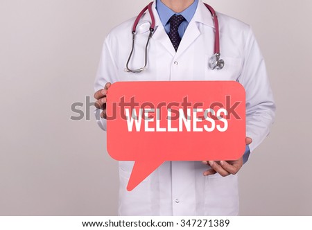 Doctor holding speech bubble with WELLNESS message