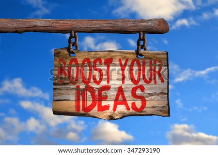 Boost your ideas motivational phrase sign on old wood with blurred background