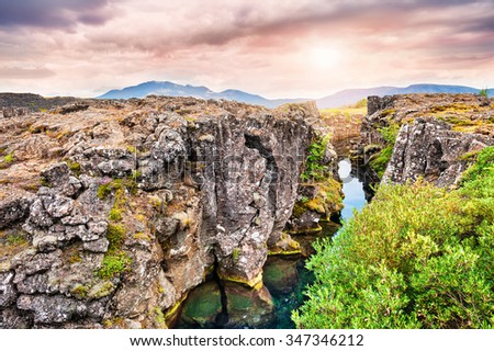 Beautiful cliffs and deep fissure in Thingvellir National Park. Southern Iceland Royalty-Free Stock Photo #347346212