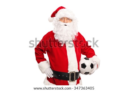 Studio shot of Santa Claus holding a soccer ball and looking at the camera isolated on white background