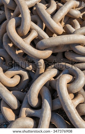 Large rusty shipping chain on floor