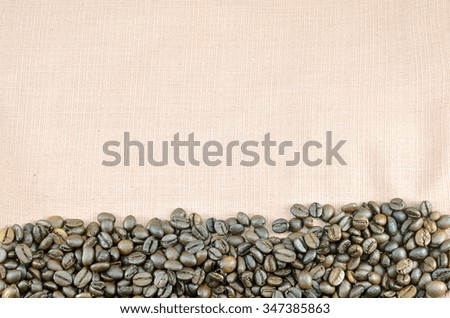 coffee bean on light brown fabric background