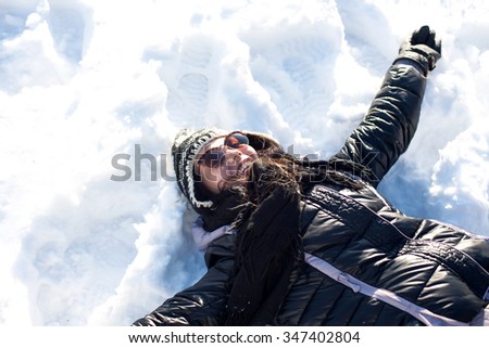 Laughing beautiful girl portrait in winter time with snow