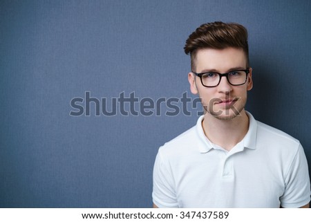 Handsome young man with glasses and a serious thoughtful expression